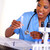 Beautiful nurse working with a test tube stock photo © pablocalvog