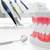 Clean teeth dental jaw model, mirror and dentistry instruments in dentist's office.  stock photo © photocreo