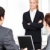 aandachtig · zakenvrouw · permanente · naar · collega's - stockfoto © pressmaster