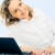 moderna · mujer · primer · plano · sonriendo · mujer · rubia · portátil - foto stock © pressmaster