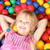 boldog · lány · színes · golyók · mosolyog · lány · arc - stock fotó © pressmaster