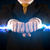 Business man holding electricity light bolt in his hands stock photo © ra2studio