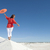 Beautiful woman balancing on sand dune rim stock photo © roboriginal