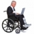 Injured businessman on laptop in a wheelchair isolated stock photo © RTimages