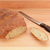 Freshly baked loaf of bread and bread knife on the table stock photo © sarahdoow