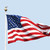 The American flag flies on a sunny day against a clear blue sky. stock photo © sarahdoow