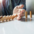 businessman hand stop dominoes continuous toppled or risk with c stock photo © snowing
