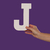 Female hand holding up the letter J from the right stock photo © stryjek