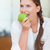 Portrait of a lovely woman eating an apple in her kitchen stock photo © wavebreak_media