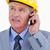 Close up of mature architect talking on the phone against a white background stock photo © wavebreak_media