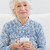 starszych · wesoły · kobieta · patrząc · kamery · sofa - zdjęcia stock © wavebreak_media