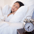 Alarm clock next to young woman sleeping in her bed stock photo © wavebreak_media