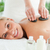 Blonde smiling woman experiencing a stone therapy in a wellness center stock photo © wavebreak_media