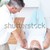 Physiotherapist massaging the lower part of the back of his patient in a room stock photo © wavebreak_media