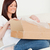 Good looking red-haired woman opening a carboard box while sitting on a sofa in the living room stock photo © wavebreak_media