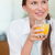 Portrait of a happy woman drinking juice in her kitchen stock photo © wavebreak_media