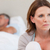 Sad mature woman on bed with her husband in the background stock photo © wavebreak_media