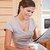 Smiling young woman reading newspaper in the kitchen stock photo © wavebreak_media