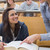 Lecturer explainging to student in lecture hall with large book stock photo © wavebreak_media