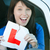 Happy brunette teen girl sitting in her car tearing a L-sign stock photo © wavebreak_media
