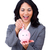 Happy ethnic businesswoman saving money in a piggybank  stock photo © wavebreak_media