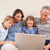 Family sitting on a sofa using a laptop in a living room stock photo © wavebreak_media