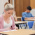 Blonde student writing note in classroom stock photo © wavebreak_media