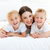 Laughing children playing with their mother lying on a bed stock photo © wavebreak_media