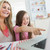 Little girl and mother laughing at laptop at kitchen table stock photo © wavebreak_media