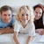 Cheerful boy under the bed cover together with his parents stock photo © wavebreak_media