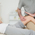 Serious osteopath massaging the knee of a patient in a room stock photo © wavebreak_media