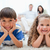 Happy smiling kids lying on the carpet with parents behind them stock photo © wavebreak_media