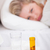 Medicines and thermometer on a beside table with a woman in her bed stock photo © wavebreak_media
