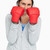 Serious brunette in sweatshirt wearing boxing gloves against white background stock photo © wavebreak_media
