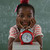Schoolgirl sitting with red apple on her head against chalkboard stock photo © wavebreak_media
