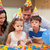 Young boy helping his little sister to blow out the candles on her birthday cake stock photo © wavebreak_media