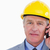 Confident mature architect with helmet on the phone against a white background stock photo © wavebreak_media