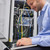 Man using laptop in front of servers in data center stock photo © wavebreak_media