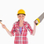 Pretty woman holding a saw and a hammer while standing against a white background stock photo © wavebreak_media