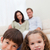 Children sitting in the living room with their parents behind them stock photo © wavebreak_media