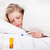 Sick blonde woman looking at her thermometer in her bed stock photo © wavebreak_media