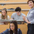 Students working while teacher smiling in lecture hall stock photo © wavebreak_media
