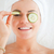 Young woman with a knowing smile with cucumber slices on the face in a spa stock photo © wavebreak_media
