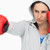 Brunette in sweatshirt boxing against white background stock photo © wavebreak_media