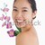 Woman smiling at camera while holding orchids stock photo © wavebreak_media