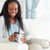 Smiling woman on sofa texting stock photo © wavebreak_media