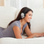 smiling woman with thumb up and earphones lying on sofa in livingroom stock photo © wavebreak_media