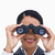 Close up of smiling saleswoman using spy glasses against a white background stock photo © wavebreak_media