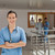 Smiling doctor standing in the hallway of a hospital while crossing her arms stock photo © wavebreak_media