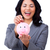 Laughing businesswoman saving money in a piggybank  stock photo © wavebreak_media